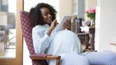 Pregnant person using tablet Pregnant person using tablet