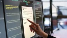 Person using AI chat touchscreen Person using AI chat touchscreen