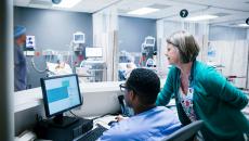 Healthcare workers using a computer Healthcare workers using a computer