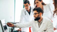 Group of healthcare professionals at a screen Group of healthcare professionals at a screen