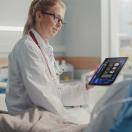 Healthcare worker showing tablet to patient Healthcare worker showing tablet to patient