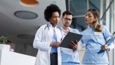Healthcare workers looking at clipboard Healthcare workers looking at clipboard