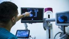 Clinician pointing at a mammography on a screen Clinician pointing at a mammography on a screen