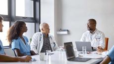 Doctors and other medical workers meeting in a conference room. Doctors and other medical workers meeting in a conference room.