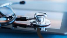Stethoscope resting on tablet Stethoscope resting on tablet