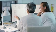 Healthcare workers looking at data on a monitor Healthcare workers looking at data on a monitor