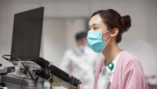 Heathcare worker at laptop Heathcare worker at laptop