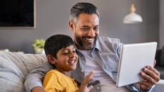 Parent and child looking at tablet Parent and child looking at tablet