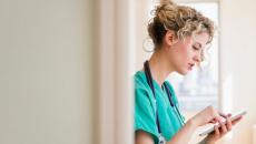 A nurse holding a digital tablet to check a patient's file A nurse holding a digital tablet to check a patient's file