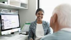 A smiling doctor facing a patient in a consultation A smiling doctor facing a patient in a consultation